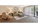 Living room with sofa, armchairs, and access to balcony at 36750 Us Highway 19 N # 19219, Palm Harbor, FL 34684