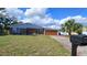 Brick ranch house with attached garage and well-maintained lawn at 400 Alma Dr, Brandon, FL 33510