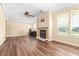 Living room with wood-look floors, fireplace, and large windows at 4043 Fox Ridge Blvd, Wesley Chapel, FL 33543