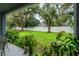 Private backyard with green lawn and mature trees at 4445 Amberly Oaks Ct, Tampa, FL 33614