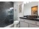 Modern bathroom with glass shower, dark tile, and vessel sink at 4445 Amberly Oaks Ct, Tampa, FL 33614