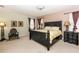Main bedroom with a king-size bed, and plenty of natural light at 4445 Amberly Oaks Ct, Tampa, FL 33614