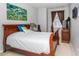 Cozy bedroom with a wooden bed frame and window coverings at 4445 Amberly Oaks Ct, Tampa, FL 33614