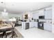 Open concept kitchen with island, dining area, and living room at 4445 Amberly Oaks Ct, Tampa, FL 33614