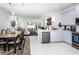 Open concept kitchen with island, dining area, and living room at 4445 Amberly Oaks Ct, Tampa, FL 33614