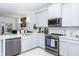 Modern kitchen with stainless steel appliances and light gray cabinets at 4445 Amberly Oaks Ct, Tampa, FL 33614