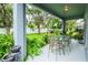 Covered patio with glass-top table and lush landscaping at 4445 Amberly Oaks Ct, Tampa, FL 33614