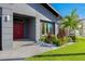 Stylish red front doors and a nicely landscaped front porch at 5204 Fern Row Ln, Tampa, FL 33611