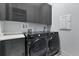 Laundry room with Samsung washer and dryer and upper cabinets at 5204 Fern Row Ln, Tampa, FL 33611