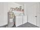 Bright laundry room with washer, dryer and shelving at 6000 Francis Drive, Apollo Beach, FL 33572