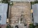 An aerial view shows new home construction with an exposed wood frame, capturing the essence of building and design at 6457 1St Palm Pt, St Pete Beach, FL 33706