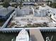 Aerial view of a house under construction near a canal with a boat in the foreground at 6457 1St Palm Pt, St Pete Beach, FL 33706