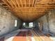 Interior view of the unfinished basement with exposed ceiling rafters and construction materials at 6457 1St Palm Pt, St Pete Beach, FL 33706