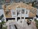 Exterior view of home under construction, showing roof framework with concrete base and waterfront access at 6457 1St Palm Pt, St Pete Beach, FL 33706