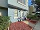 Exterior of house with light blue paint, red mulch, and landscaping at 6600 121St Ave # 9, Largo, FL 33773