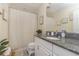 Bathroom with granite countertop, white cabinets, and a shower/tub combo at 7013 Summer Holly Pl, Riverview, FL 33578