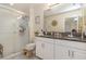 Clean bathroom with a walk-in shower, double vanity, and granite countertop at 7013 Summer Holly Pl, Riverview, FL 33578