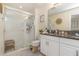 Clean bathroom with a walk-in shower, double vanity, and granite countertop at 7013 Summer Holly Pl, Riverview, FL 33578