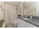 Bathroom with granite countertop, white cabinets, and a shower/tub combo at 7013 Summer Holly Pl, Riverview, FL 33578