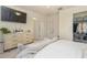 Bedroom with large bed, dresser, and access to bathroom and closet at 7013 Summer Holly Pl, Riverview, FL 33578