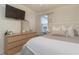 Bedroom with dresser, mirror, and a bed with soft bedding at 7013 Summer Holly Pl, Riverview, FL 33578