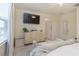 Bedroom with large bed, dresser, and access to bathroom and closet at 7013 Summer Holly Pl, Riverview, FL 33578