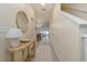 Bright and airy entryway with a console table and mirror, leading to the living area at 7013 Summer Holly Pl, Riverview, FL 33578