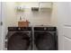 Laundry room with Samsung washer and dryer and overhead shelving at 7013 Summer Holly Pl, Riverview, FL 33578