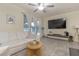 Living room features a large TV, comfortable seating, and neutral color palette at 7013 Summer Holly Pl, Riverview, FL 33578