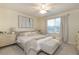 Main bedroom with a king-size bed, and large window at 7013 Summer Holly Pl, Riverview, FL 33578