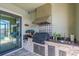 Close-up of a gorgeous outdoor kitchen with stainless steel appliances, ample counter space and storage at 710 16Th E Ave, Palmetto, FL 34221