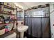 Bathroom with pedestal sink, shower/tub combo, and storage at 7201 Park S St, St Petersburg, FL 33707