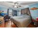 Main bedroom with a king-size bed, hardwood floors, and plenty of natural light at 7201 Park S St, St Petersburg, FL 33707