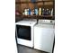 Laundry room with washer, dryer, and ample storage shelves at 906 Oakland Heights Ave, Plant City, FL 33563