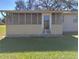 Enclosed porch with tiled floor and seating area, perfect for relaxing outdoors at 906 Oakland Heights Ave, Plant City, FL 33563