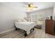 Cozy bedroom with a queen-size bed and hardwood floors at 9723 Rolling Cir, San Antonio, FL 33576