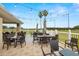 Outdoor patio with tables, string lights, and golf course view at 9723 Rolling Cir, San Antonio, FL 33576