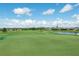 Expansive golf course with a pond and residential homes in the background at 9723 Rolling Cir, San Antonio, FL 33576