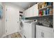 Bright laundry room with washer, dryer, and extra storage at 9723 Rolling Cir, San Antonio, FL 33576