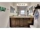 Double vanity bathroom with granite countertop and large mirror at 10439 Waterstone Dr, Riverview, FL 33578