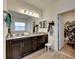 Double vanity bathroom with granite countertop and large mirror at 10439 Waterstone Dr, Riverview, FL 33578