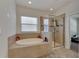 Bathroom with a large soaking tub and walk-in shower at 10439 Waterstone Dr, Riverview, FL 33578