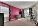Spacious bedroom with pink accent wall and crib at 10439 Waterstone Dr, Riverview, FL 33578