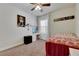 Cozy bedroom with floral bedding, ceiling fan, and built-in desk area at 10439 Waterstone Dr, Riverview, FL 33578