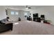 Spacious bonus room with large windows, ceiling fan, and plenty of space at 10439 Waterstone Dr, Riverview, FL 33578