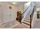 Entryway with double doors, coat rack and carpeted stairs at 10439 Waterstone Dr, Riverview, FL 33578