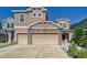 Two-story house with a two-car garage and stone accents at 10439 Waterstone Dr, Riverview, FL 33578