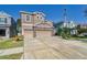 Two-story house with a two-car garage and landscaped yard at 10439 Waterstone Dr, Riverview, FL 33578