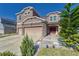 Two-story house with a large stone and beige exterior, red door, and a three-car garage at 10439 Waterstone Dr, Riverview, FL 33578