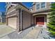 Exterior view of three car garage and home entrance at 10439 Waterstone Dr, Riverview, FL 33578